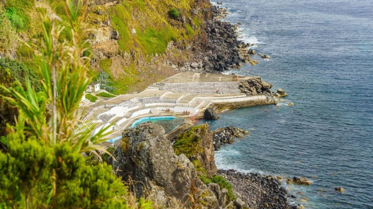 Coastal view with a terraced rocky landscape and ocean waters.
