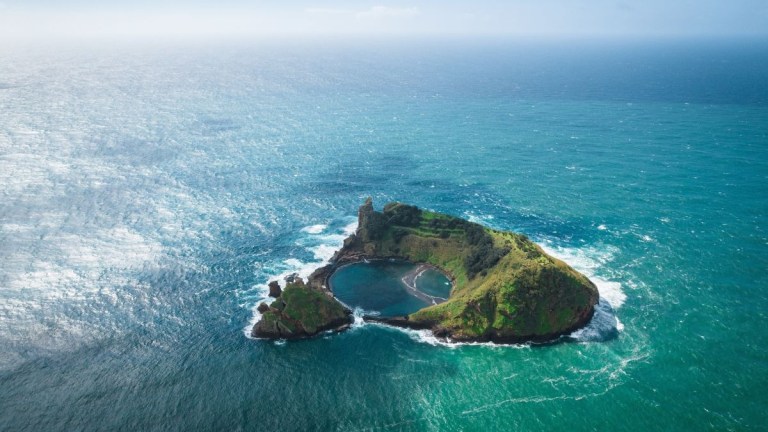 Small island with a crater lake surrounded by ocean.