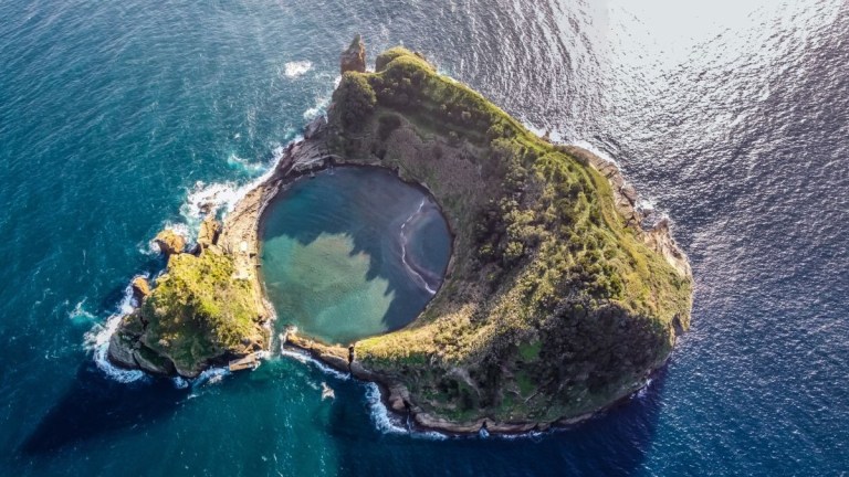 Aerial view of a small, circular island with a central lagoon.