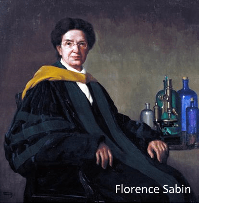 A person in academic robes with scientific instruments on a table.